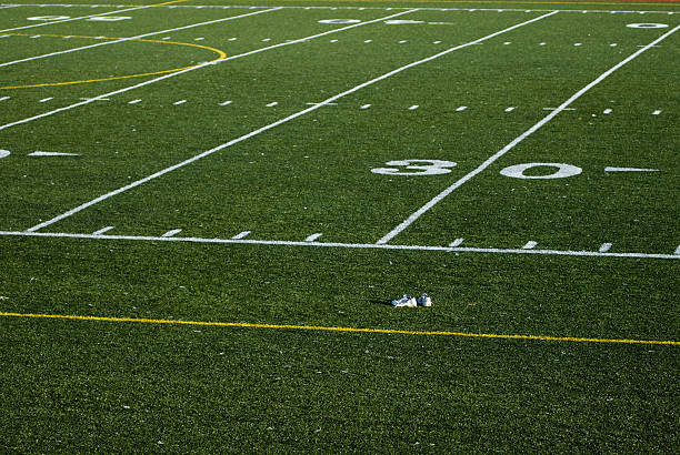 Shoes on a Football Field stock photo
