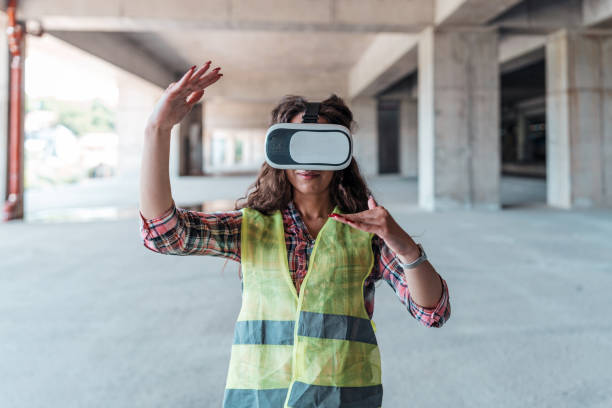 istock Woman inspector analyzing the work of builders using virtual reality glasses. 1404518642