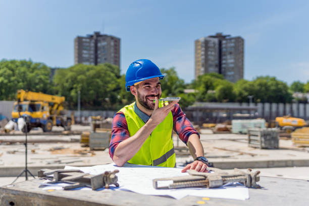 istock Young engineer working on outdoor project and talking on phone 1404518682