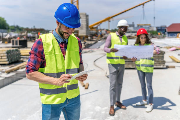 istock Group of builders with tablet and blueprint 1404518686