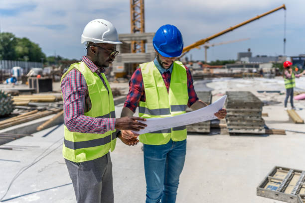 istock Group of builders with blueprint 1404518687