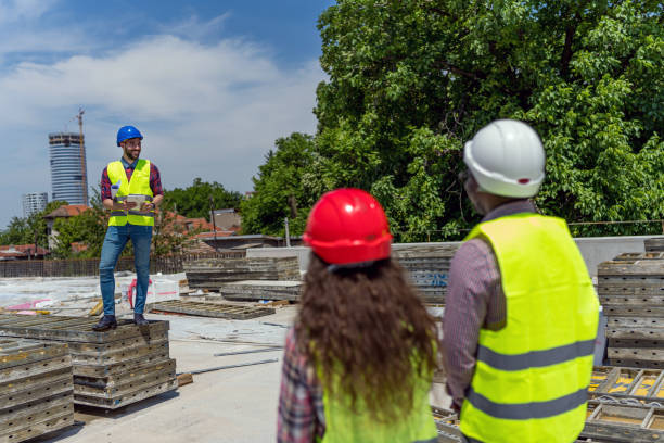 istock Group of builders with tablet and blueprint 1404518703