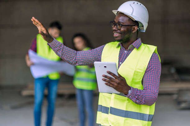istock Group of builders with tablet and blueprint 1404518721