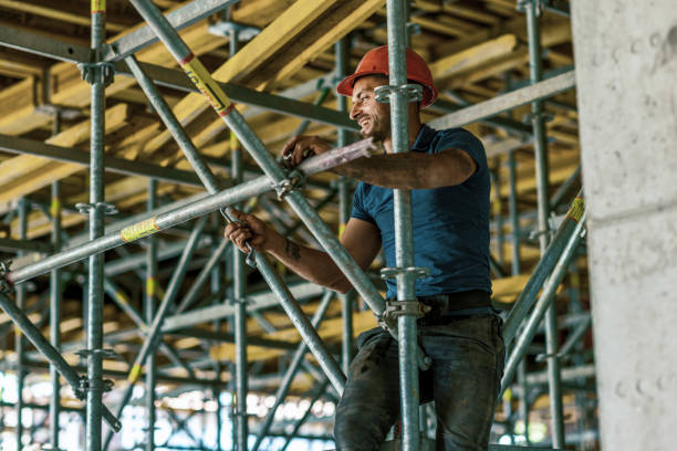 Builder Putting Up Scaffolding Portrait Of Confident Bricklayer At Construction Site scaffolding stock pictures, royalty-free photos & images