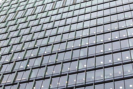 Closeup modern corporate glass building, background with copy space, full frame horizontal composition
