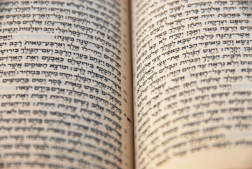 Close up on the holy bible in Hebrew, focus on the middle the rest is on the move