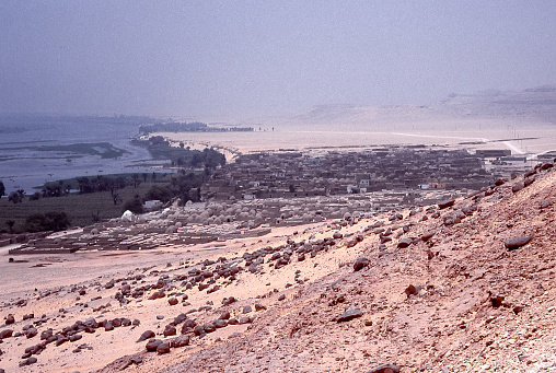 Tell El Amarna, Egypt - aug 08, 1991: the new city of Amarna rises on the banks of the Nile river near the archaeological site of Tell El Amarna, the capital of the pharaoh Akhenaten and his god Aton.