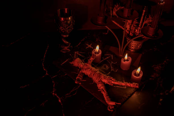 istock Voodoo Doll on a wooden background with dramatic lighting. 1404523067