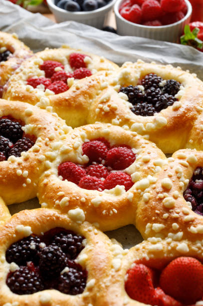 Homemade sweet yeast buns with the addition berries and butter crumble, close up view