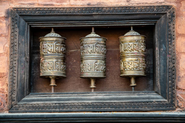 Prayers wheels Kirtipur, Kathmandu Valley, Nepal - oct 29, 2019:  three prayer wheels are found inside the Chilancho Bihar temple in Kirtipur, Kathmandu Valley prayer wheel nepal kathmandu buddhism stock pictures, royalty-free photos & images