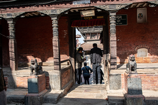 Kirtipur, Kathmandu Valley, Nepal - oct 29, 2019:  a narrow door leads to the courtyard of the famous Bagh Bhairab temple in Kirtipur, Kathmandu Valley