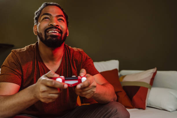 istock Happy African-American man play video game 1404525109