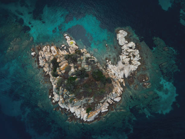 istock Drone view above small rocky island with green vegetation. 1404530565