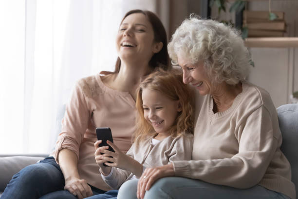 istock Happy family using cellphone apps at home. 1404530849