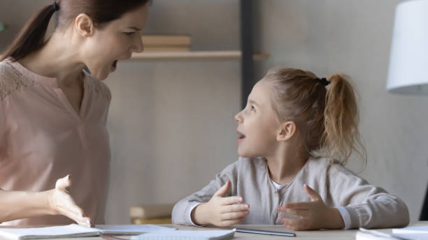 istock Angry strict young mother arguing with stressed small kid daughter. 1404531542
