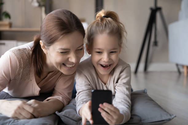 istock Happy two generations family using cellphone at home. 1404531785