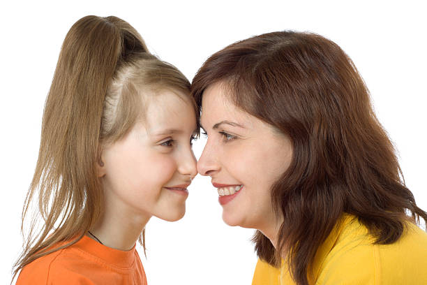Mother and the daughter happily look against each other stock photo