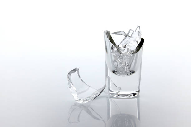 istock Shards of broken glass goblet and reflection on white background. 1404532993