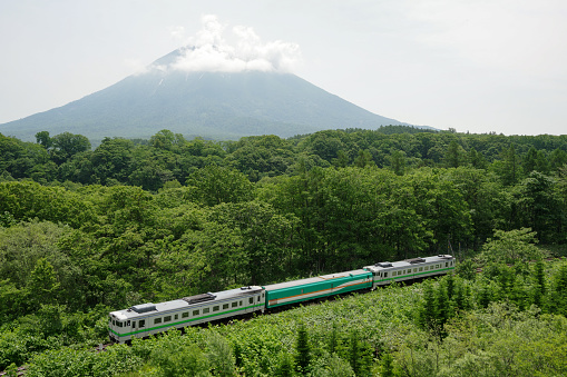 Kutchan-cho, Hokkaido, Japan - June 22, 2022 : Mount Yotei and KIHA40+MAYA35 Inspection train