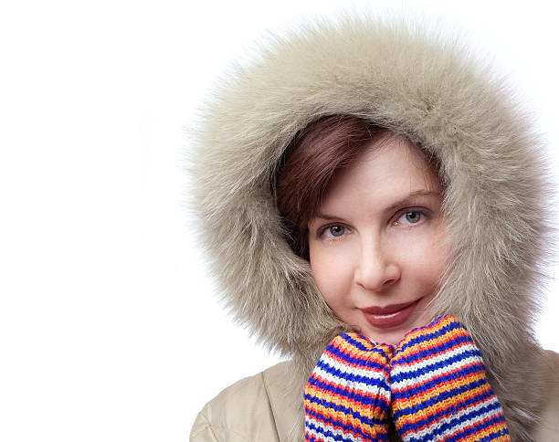 Beautiful smiling girl in a hood and gloves stock photo