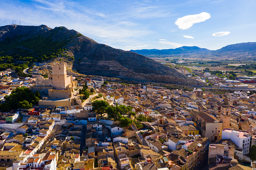 View from drone of cityscape of Villena and medieval moorish Atalaya castle on sunny fall day, Alicante, Spain