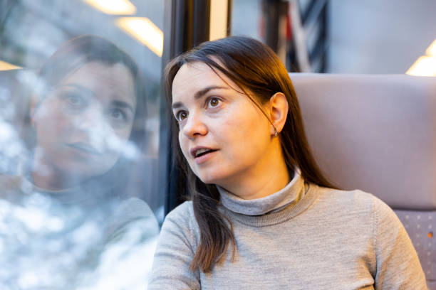 istock Interested surprised woman looking out window while travelling by train 1404537404