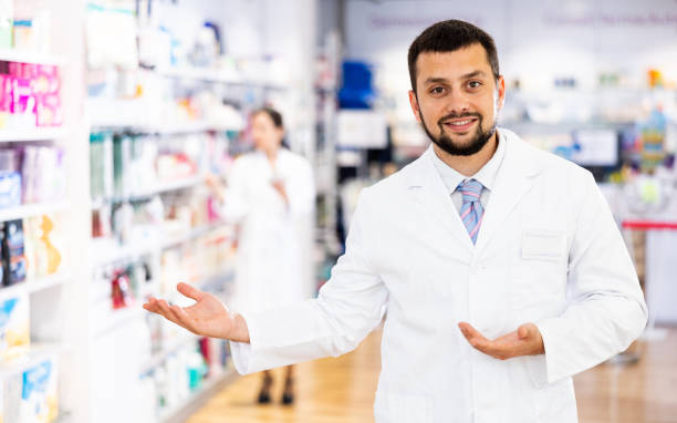 istock Portrait of positive druggist making presenting gesture 1404537978