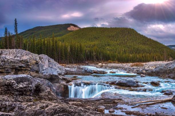 Morning Clouds Over Elbow Falls A cloudy morning sky over Elbow Falls in Bragg Creek in the springtime. kananaskis country stock pictures, royalty-free photos & images