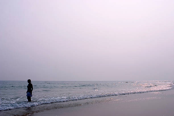istock One person standing on the beach with sun 2 140453951