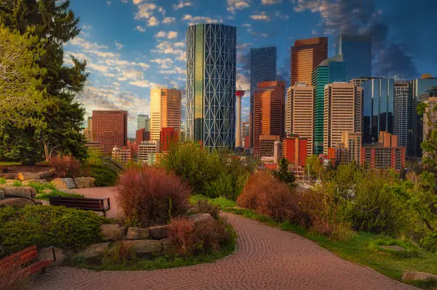 A panoramic sunrise sky glowing over the downtown Calgary skyline in the springtime.