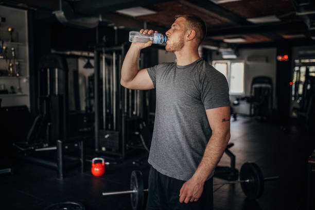 istock Man drinking water in gym 1404540945