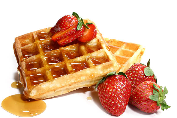 stack of waffles with four strawberries and syrup - stroopwafel stockfoto's en -beelden