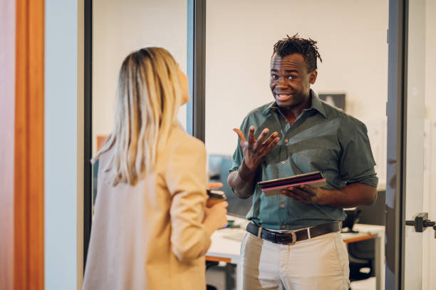 istock Two multiracial business colleagues working together on a digital tablet 1404542237