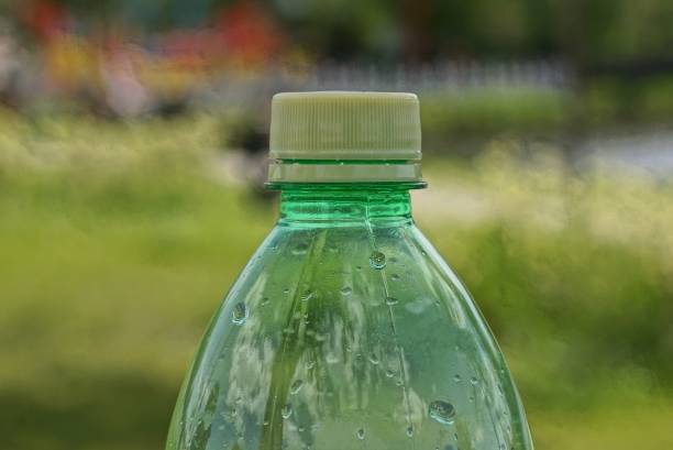 istock part of one plastic green bottle closed with a yellow cork 1404543808
