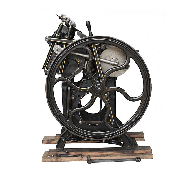 antique printing press isolated 1901 black printing press showing the flywheel and gold detailing isolated against a white background letterpress photos stock pictures, royalty-free photos & images