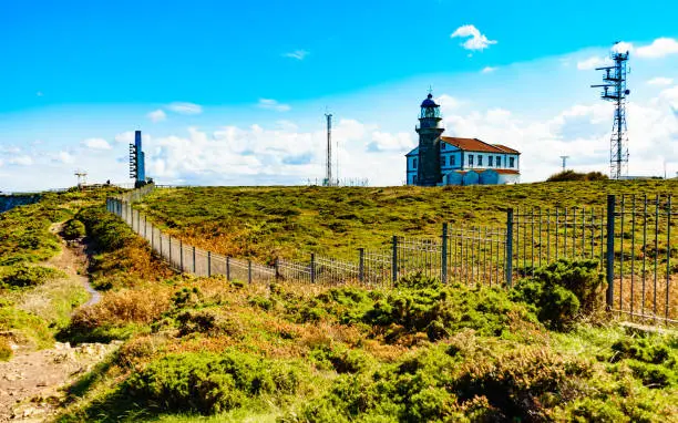 Sea coast landscape with fog horns and lighthouse on Cabo Penas in north Spain, Bay of Biscay, Asturias coastline. Tourist attraction.