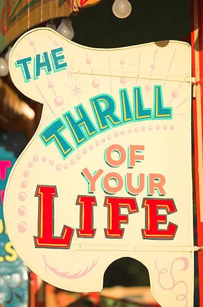 Sign at a fairground reading ""The Thrill of your Life""