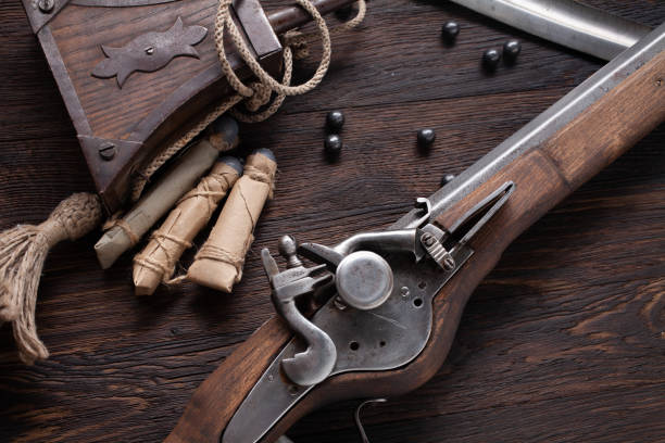 17th century ancient flintlock musket with powder flask and led bullets. - 17th century style imagens e fotografias de stock