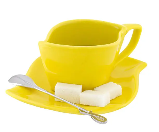 Yellow a tea service with the spoon and sugar