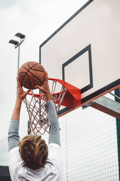 istock Waist up unrecognizable basketball player making a slam dunk 1404553557