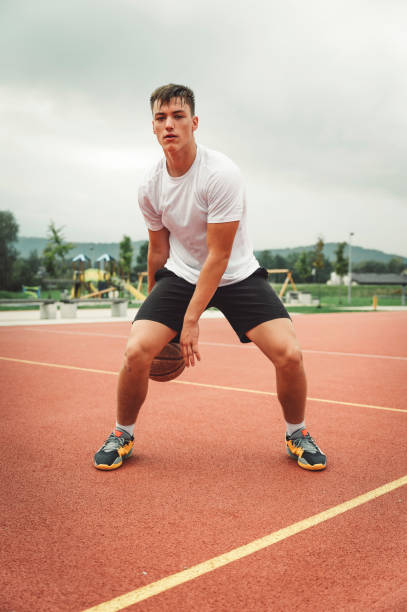 istock Man dribbling a basketball in between his legs 1404553563