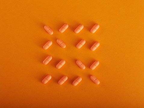 Orange Pills Over Orange Background