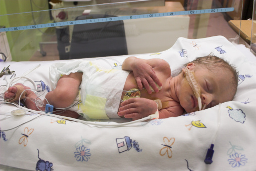 Premature baby sleeping in ICU only one day old