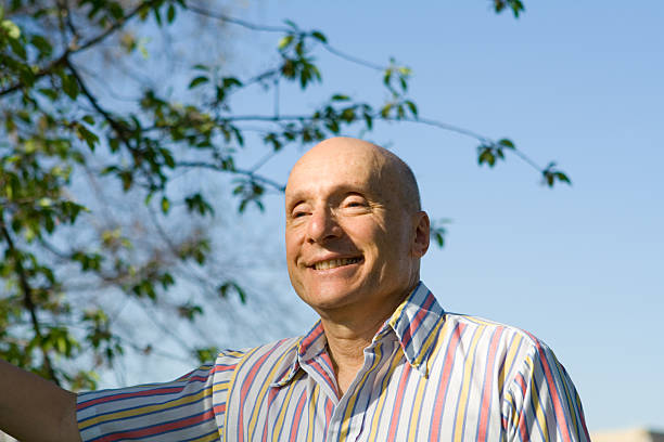 istock Bald Senior Man Smiling Outside Striped Shirt 140455546