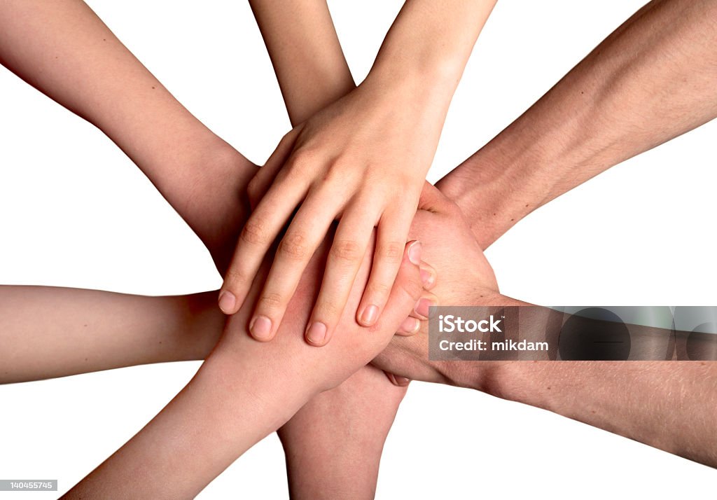 A group of hands on top of each other as a sign of unity united hands Adult Stock Photo