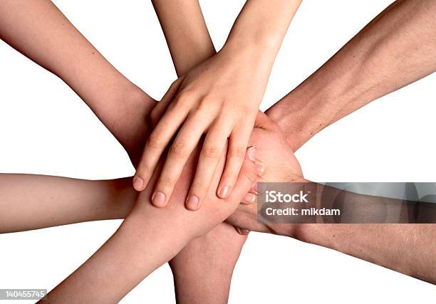 A Group Of Hands On Top Of Each Other As A Sign Of Unity Stock Photo - Download Image Now