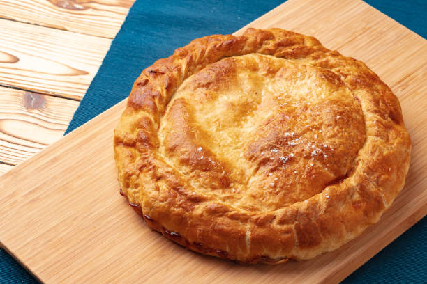 istock Apple pie on a wooden board close up 1404557828