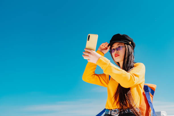 istock young woman using a mobile phone 1404558277