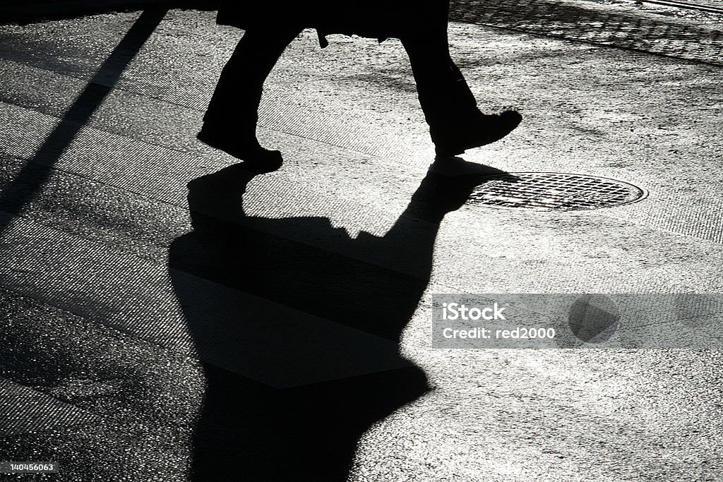Pedastrian Pedastrian crossing the street by passage. Silhouette. Asphalt Stock Photo
