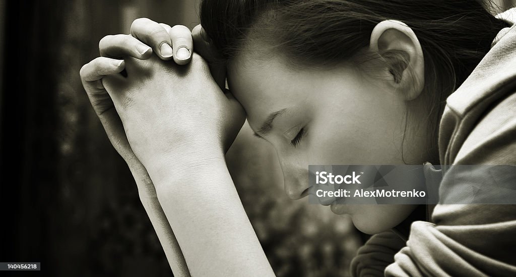 Sincere Prayer Young girl praying Confession Booth Stock Photo